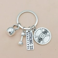 Detail of silver fitness keychain with kettlebell, dumbbell and Strong Is Beautiful tag - Large Dumbbell STRONG