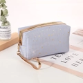 Light blue cosmetic bag with gold star pattern, zipper closure and top handle - Light Blue