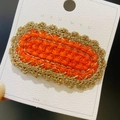 Handmade orange knit hair clip with gold metallic wire embroidery on a white display card - 16# Gold Thread Oval Orange