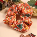 Detail of orange Christmas scrunchie with festive patterns of pine trees and bells - Christmas Style 4 (Orange Festive Elements)