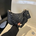 Detail of black quilted shoulder bag with ruched handle and matching mini coin purse - Black