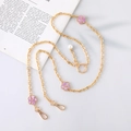 Detail of gold chain crossbody phone strap with purple floral charms and pearl accent - Gold Chain + Purple Flower