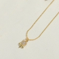 Détail d'un pendentif fleur étoile doré raffiné avec feuilles et cristaux de zircon - Fleur / Doré