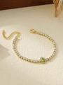 Detailed close-up of gold tennis chain bracelet with white zircons and green pear-cut stone - Green Teardrop Style (ZHB696 Green)