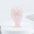 Handmade pink rose quartz crystal angel figurine in prayer pose on a white base - Rose Quartz