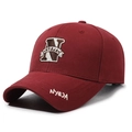 Classic dark red baseball cap featuring letter N embroidery and cotton fabric texture - Burgundy