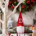 Christmas gnome ornament with red knitted hat featuring a white embroidered letter D - Knitted Alphabet Gnome D