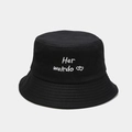 Detail showing the white 'Her weirdo' embroidery and heart icons on a black cotton bucket hat - Embroidered Style / Black (Her weirdo)
