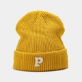 Close-up of yellow chunky knit beanie featuring a white towel-embroidered P letter - Yellow