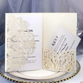 Elegant cream white laser-cut lace wedding invitation set with RSVP cards on gold tray - Ivory