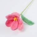 Detailed view of handmade pink crochet tulip flower with green stem on white background - Mohair Tulips - Pink Series