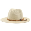 Close-up of cream straw Fedora hat featuring a brown leather braided band and metal beads - Beige