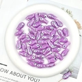 Macro detail of glossy purple fish-shaped ceramic beads for DIY jewelry making - Purple