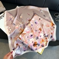 Elegant floral satin square scarf in lilac purple and pink draped on a black sofa - 98 Square Scarves / 65