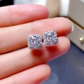 Silver square stud earrings with 2 carat square-cut center stone on finger - 2ct Square Halo Stud Earrings (E0278) / White Gold