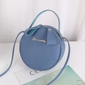 Blue round crossbody bag with pebbled leather texture and top handle for women - Blue