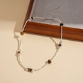 Close-up of tiger eye beaded necklace with silver metal beads and adjustable lobster clasp - Silver (HN10277)
