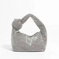 Close-up of sparkling silver rhinestone handbag featuring a stylish knotted handle design - Silver