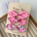 Three-piece set of girls' bow hair clips featuring pink floral and plaid fabric patterns - Pink Series