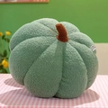Green plush pumpkin decorative pillow shown on a pink checkered surface for home decor - 23cm / Green