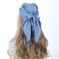 Rear view of a blue satin silk square scarf worn as a hair wrap for styling - 70cm x 70cm / Haze Blue