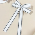 Detail van witte haarspeld met strik en pied-de-poule rand in elegante Franse stijl - Wit