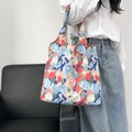 Detail of floral canvas tote bag showing artistic oil painting patterns and texture - Blue Red Floral