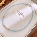 Detail of sky blue crystal beads and gold spacers on an elegant pearl necklace - 1# Blue Cylinder Style
