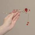 Detailed view of golden branch hair stick with red floral accents and tassel beads - Red Plum Blossom