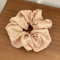 Champagne pink scrunchie with shiny satin texture on a natural wooden background - Large / Light Pink
