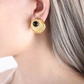 Vintage gold hoop earrings with black onyx center and sunburst texture on model - Black Imitation Pearl (Gold Tone)
