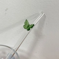 Heat-resistant glass straw featuring a delicate green butterfly glass ornament - Green
