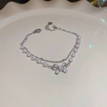 Close-up of double-layer pearl bracelet with a sparkling zircon bow pendant - Silver Bow Double Layer Bracelet