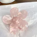 Pink flower-shaped hair claw clip with pearlescent finish on white textured paper - Flower 6.5cm / Holographic Pink