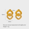Detailed view of gold earrings with spiral texture and white cubic zirconia accents - Double Ring Stud Earrings