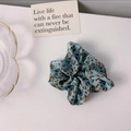Detail of silk hair scrunchie with blue and brown leopard pattern on white background - Blue Leopard Print
