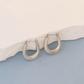 Detailed close-up of silver U-shaped oval earrings with spiral textured pattern - Silver Spiral Striped Stirrup