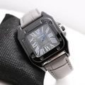 Detail of square quartz watch with Roman numerals and blue hands on a grey leather strap - Grey Strap Black Dial