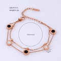 Detailed view of rose gold double-layer bracelet with black and white shell charms - Black and White (Rose Gold Chain)