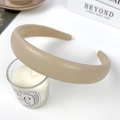 Minimalist beige padded leather headband for women shown on a clean studio background - Light Coffee