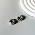 Detailed view of silver polished hoop earrings on a minimalist decorative background - DD-TE157-Silver