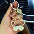 Handheld Sakura acrylic quicksand keychain with gold ring and green tag charm - Yellow