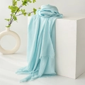 Light blue cotton linen scarf with natural crinkle texture and fringed edges on display - Mint Green