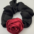 Elegant satin hair tie featuring a dark red rose decoration on a black scrunchie band - Red