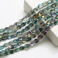 Macro detail of 10x12mm iridescent crystal twisted beads for DIY jewelry making - Rose Red Green