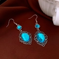 Detailed shot of bohemian oval blue resin earrings with silver filigree on silk fabric - Ear Hook - Silver - Blue