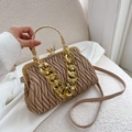 Elegant beige ruched handbag with gold chain strap and metal handle in lifestyle view - Khaki