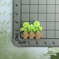 Close-up of resin flower fence charm measured with a ruler for craft DIY projects - Green Flower Fence