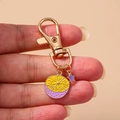 Fresh yellow and purple lemon slice keychain with star pendant on a gold ring - Purple