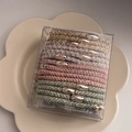 Detailed view of elastic hair bands in a PVC box on a white ceramic petal-shaped tray - 3# Morandi Color Hair Tie Set